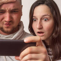 Couple shocked by something on a smartphone